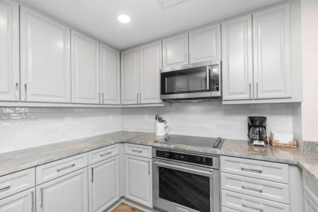 Modern kitchen featuring the Best Quartz Countertops with a polished white finish, installed by Superior Granite.