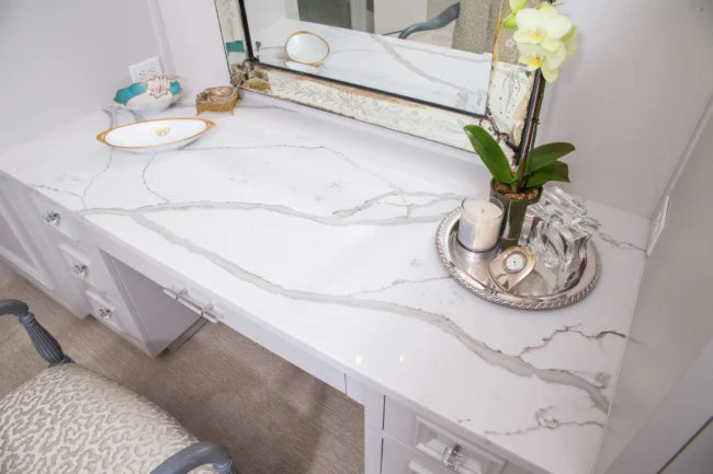 Elegant small home kitchen with light-colored polished granite countertops reflecting natural light, showing modern and space-saving granite design tips.