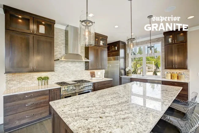A modern kitchen featuring high-quality Granite Countertops for Kitchens & Bathrooms by Superior Granite, paired with dark wood cabinetry and a large marble-patterned island. A modern kitchen featuring high-quality Granite Countertops for Kitchens & Bathrooms by Superior Granite, paired with dark wood cabinetry and a large marble-patterned island.