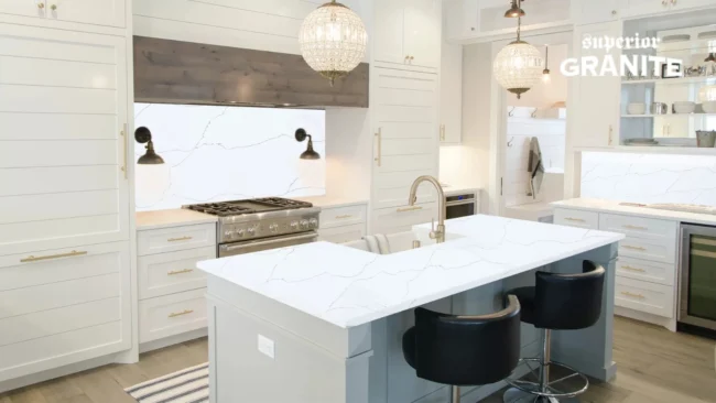 Modern white kitchen with a large island and matching backsplash, highlighting various quartz countertop colors that perfectly complement the sleek cabinetry.