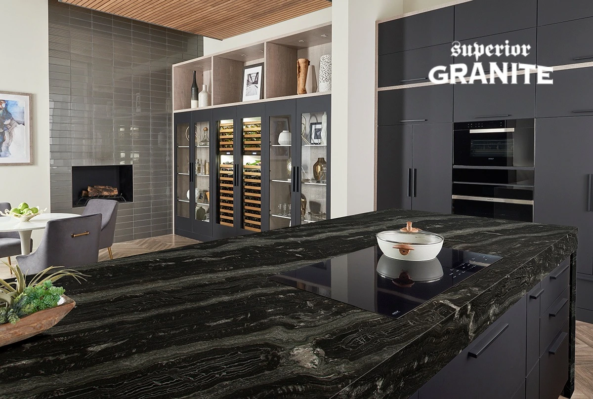 Modern kitchen with elegant black granite countertop island, dark cabinets and built-in cooktop.