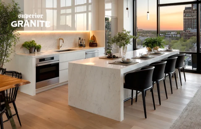 Modern kitchen featuring a white waterfall countertop island with black chairs and a city view.