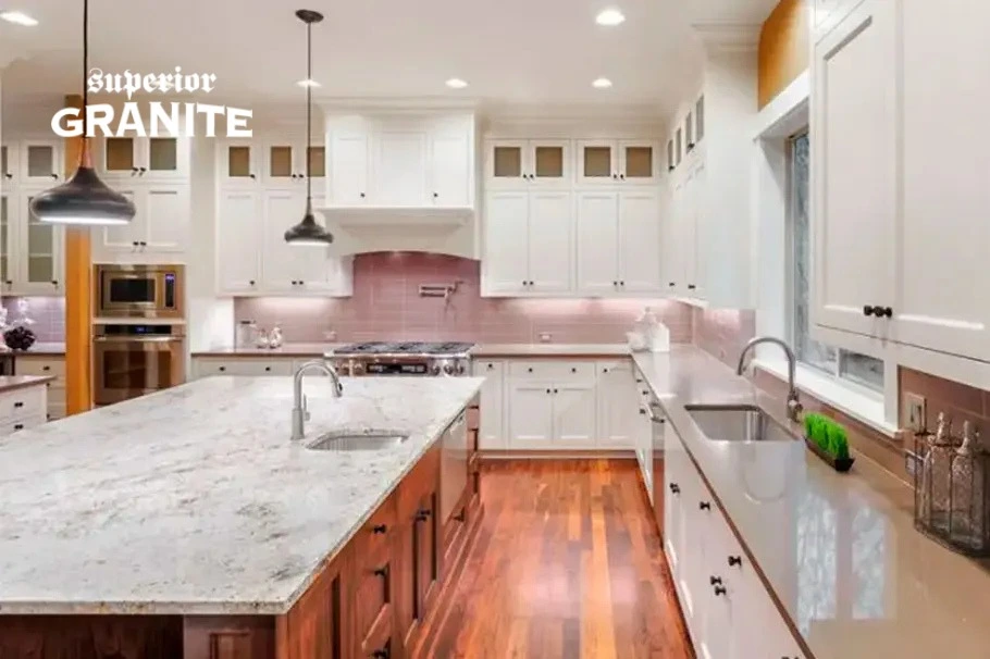 Elegant kitchen featuring white cabinetry and smooth Soapstone Countertops on the island.