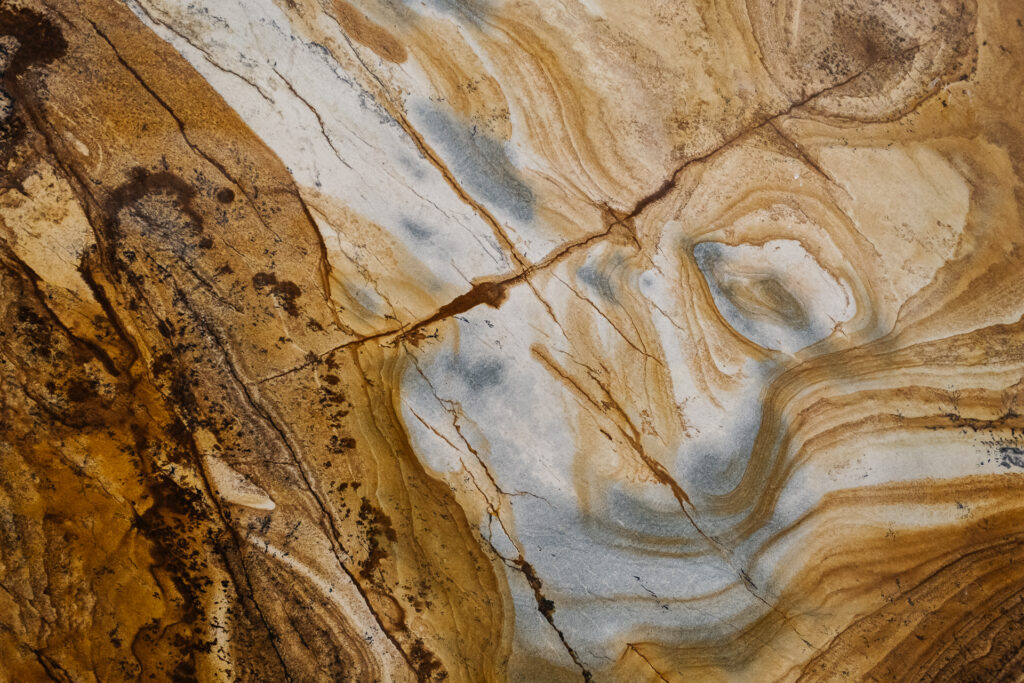 Natural granite stone veining pattern in gold and grey tones for coastal Florida countertops