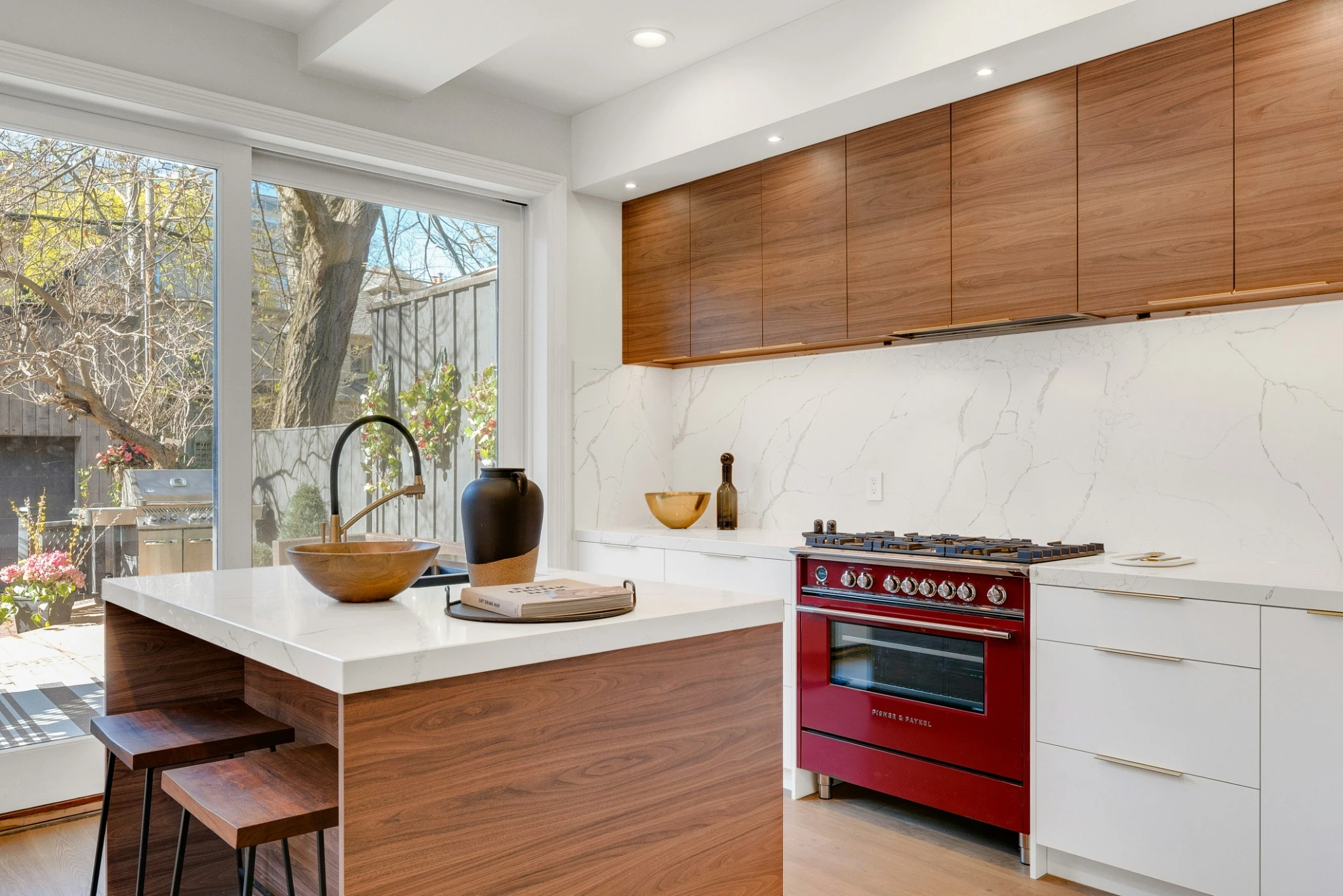 Modern kitchen with marble slab backsplash and island: Natural Stone Countertops.