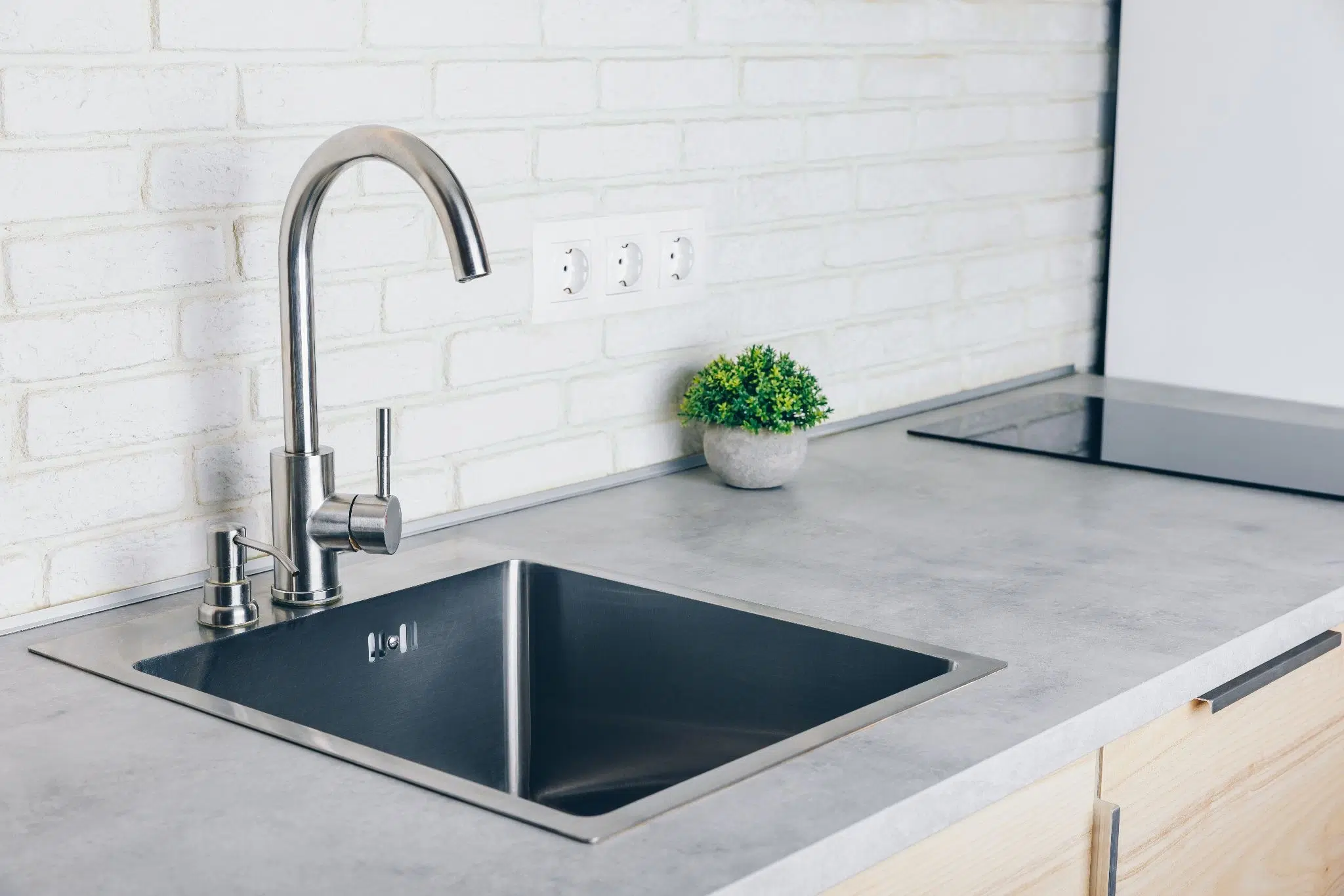 Modern undermount stainless steel basin installed in countertop for Types of Kitchen Sinks.