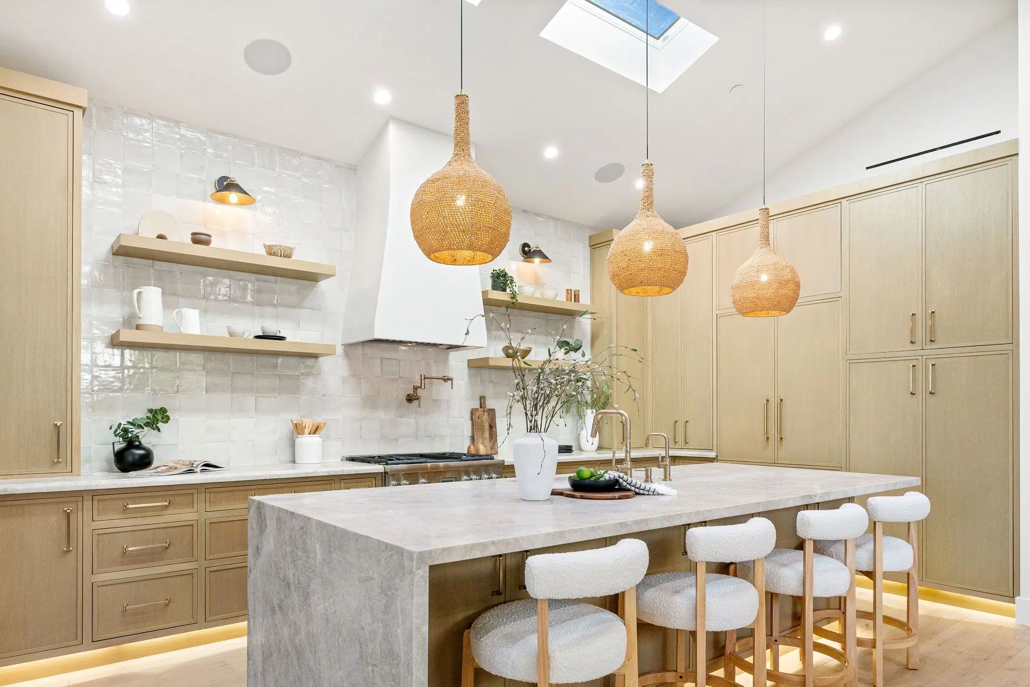 Modern kitchen island with light gray stone surface for calcite countertops design.