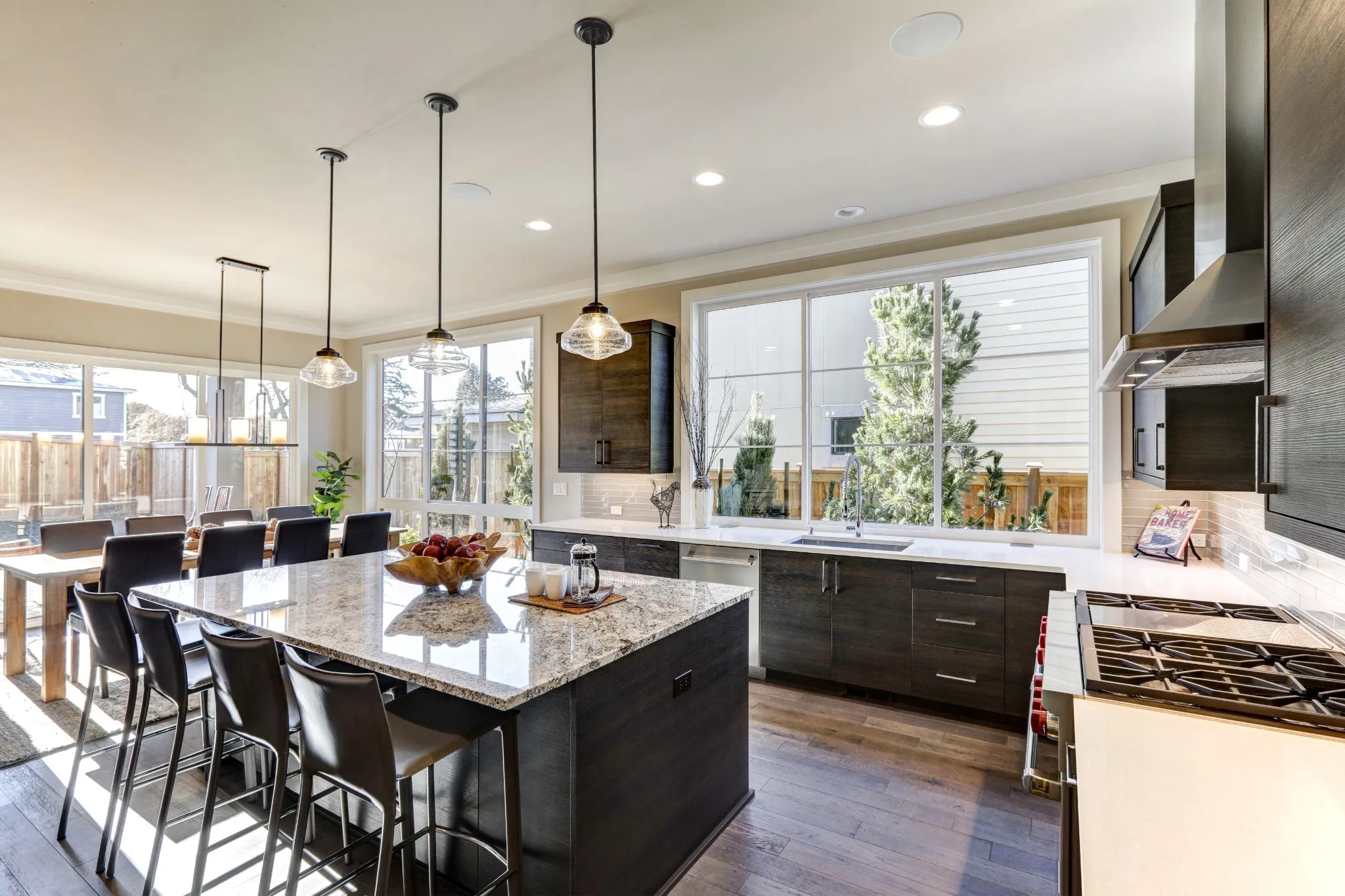 Sunlit granite island showing how natural lighting affects countertops in a open kitchen.