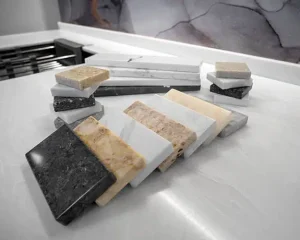 Stone and quartz material samples on display to evaluate Countertop Material Pros and Cons.