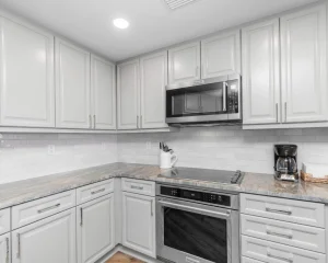 Modern kitchen featuring the Best Quartz Countertops with a polished white finish, installed by Superior Granite.