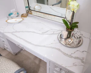 Elegant small home kitchen with light-colored polished granite countertops reflecting natural light, showing modern and space-saving granite design tips.