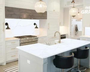 Modern white kitchen with a large island and matching backsplash, highlighting various quartz countertop colors that perfectly complement the sleek cabinetry.