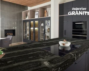 Modern kitchen with elegant black granite countertop island, dark cabinets and built-in cooktop.