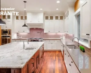 Elegant kitchen featuring white cabinetry and smooth Soapstone Countertops on the island.