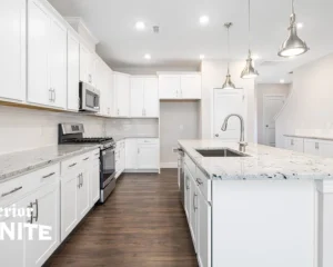 Bright modern white kitchen with island and Quartzite countertops cost details in stylish home design setup
