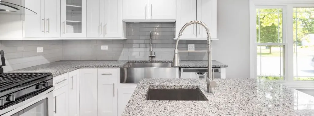 Trendy Kitchen with Subway Tile Backsplash and Granite Countertops