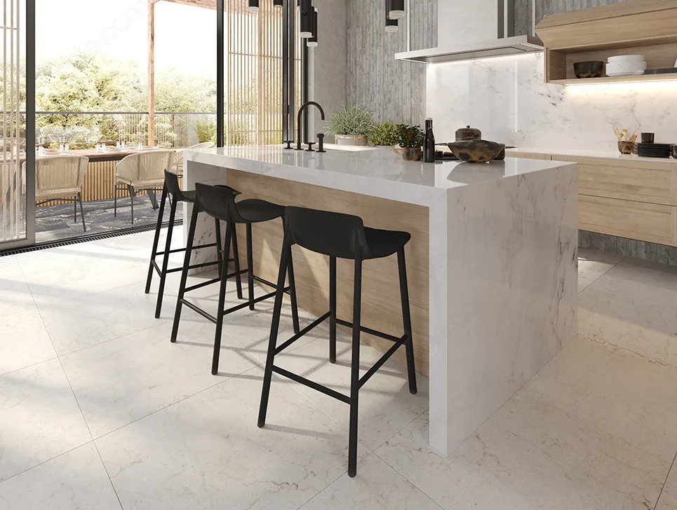 White marble island with Waterfall Countertops and black stools.