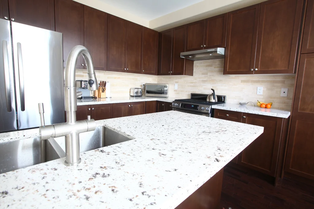 Spotted kitchen island countertop discussing Do You Need to Seal Quartz surface care.
