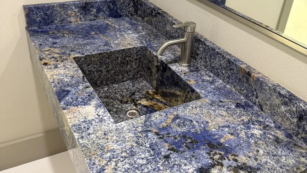 Integrated blue granite stone basin vanity illustrating unique Types of Kitchen Sinks.