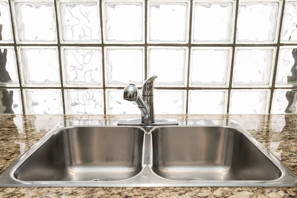 Double-basin stainless steel drop-in unit in granite for classic Types of Kitchen Sinks.