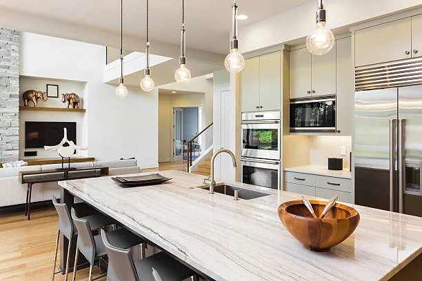 Modern kitchen island with white veined slab showing Eased Edge on Quartzite Countertops.
