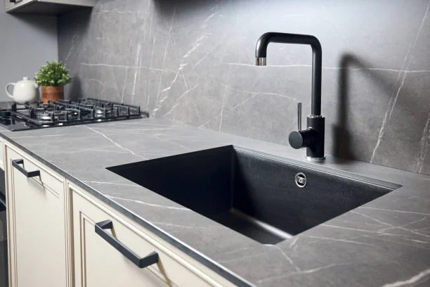 Matte black composite undermount basin set in quartz for modern Types of Kitchen Sinks.