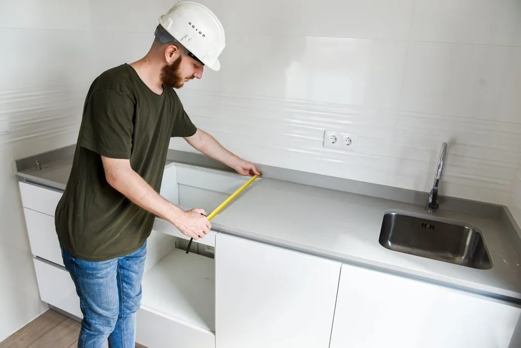 Professional measuring kitchen surface for countertop fabricator vs installer fitting.